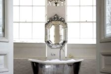 22 a shiny silver free-standing bathtub, a matching vintage mirror and a crystal chandelier