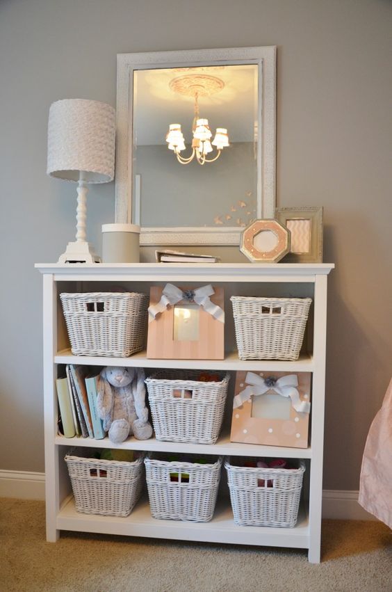 a whitewashed dresser with baskets to store all the stuff your kids need