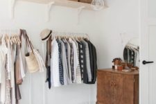 23 a makeshift closet in a serene bedroom takes one wall and there’s much storage space