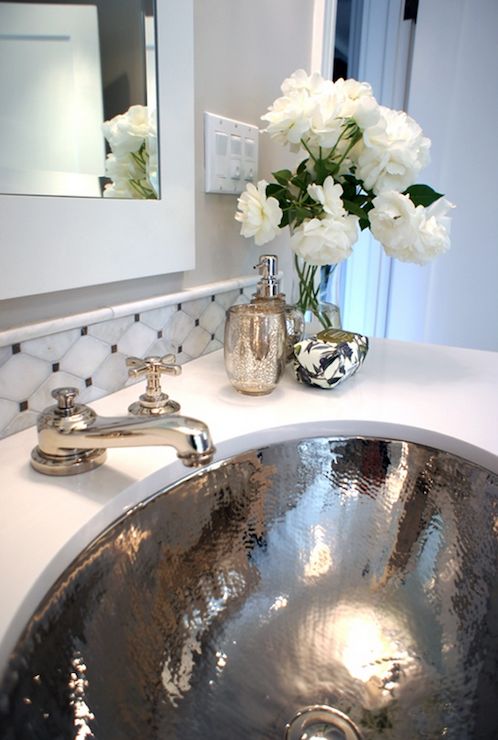 a shiny silver sink and matching faucets are great for a glam bathroom