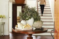 23 a vintage rustic table in the entryway can be used for various displays, seasonal and holiday ones