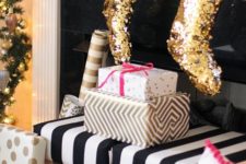 23 gold glitter stockings will add a fun and glam touch to the mantel