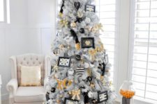 24 a modern glam Christmas tree with gold, black and white decor and ornaments, letters and feathers
