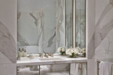 24 light-colored marble and a built-in mirrored vanity and mirrors on three sides