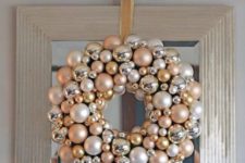 25 a glam champagne, silver and pearl ornament wreath is a great piece to DIY