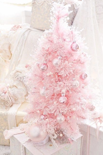 a pink Christmas tree with pearly and pink ornaments looks very sweet and glam