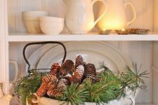 25 a soup bowl with evergreens and pinecones is ideal for cozy rustic decor in the kitchen