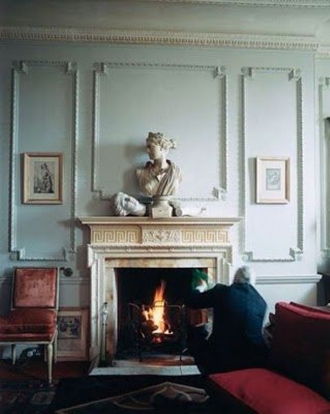 gorgeous mint-colored paneled walls and a fireplace clad with marble