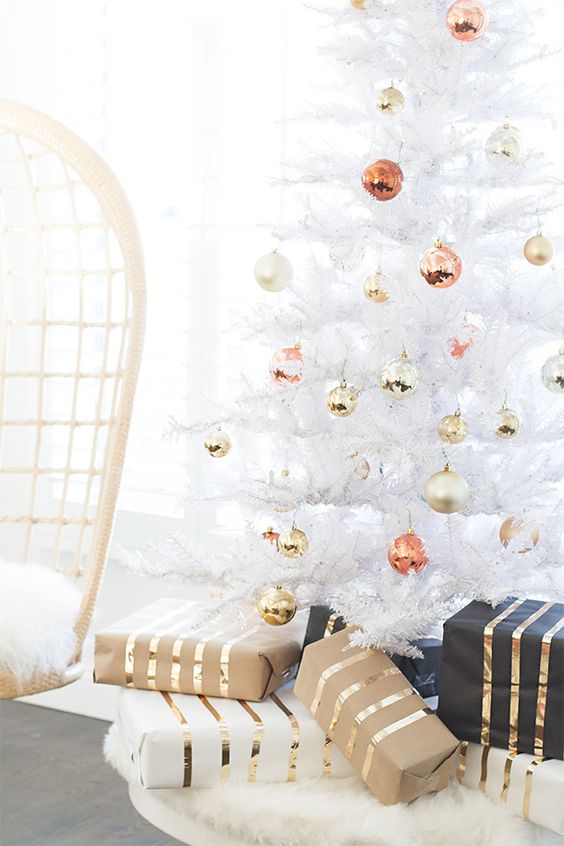 a pure white Christmas tree with ornaments of mixed metal colors looks glam and stylish