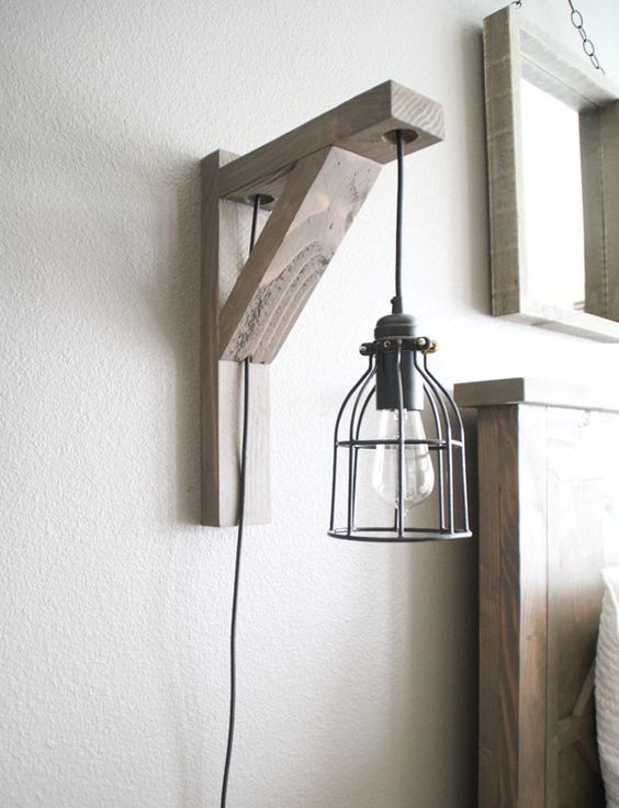 a wood and metal wall sconce that combines and pendant lamp and a sconce in one