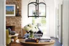 26 a wood pedestal table with books and a vase serves a great eye-catchy piece