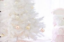 27 a pure white Christmas tree with pastel ornaments will bring a vintage glam feel to your space