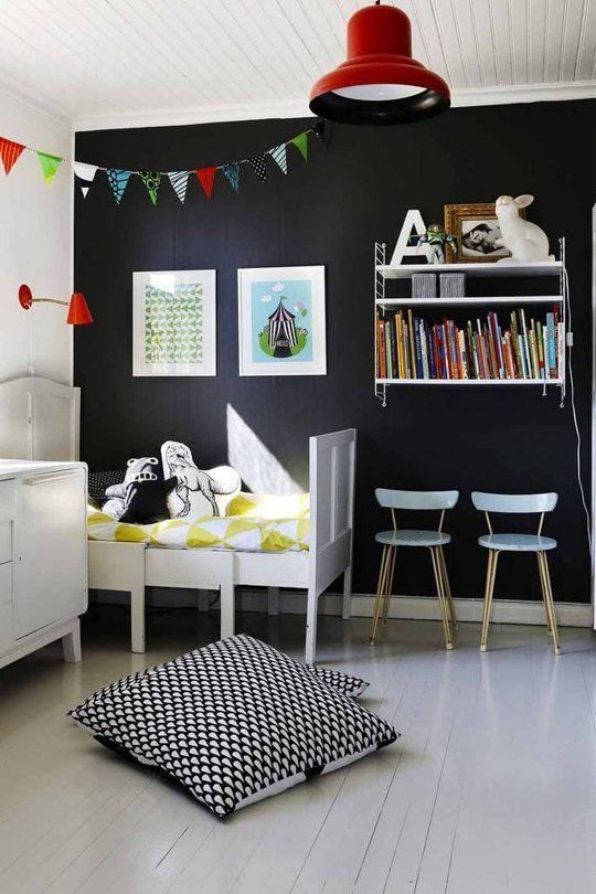 Refresh a black statement wall with artworks and books to make it cooler