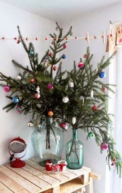 some evergreen branches with colorful vintage ornaments as an alternative to a Christmas tree