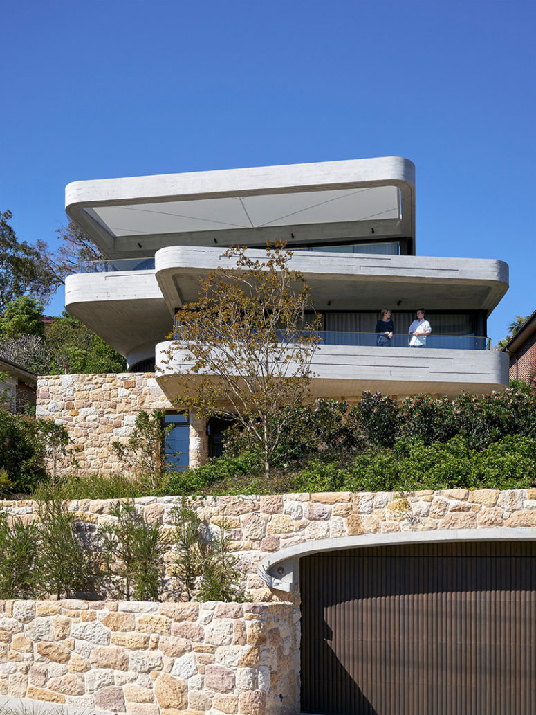 Books House is a chic concrete slab and snadstone home on a side of Sydney's harbor
