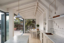01 This airy white kitchen and dining zone is opened to outdoors as much as possible and feels very light and airy
