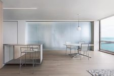 01 This minimalist apartment features amazing views of the Michigan Lake and nothing distracts from them, the color palette is rather cooling to match the water surface