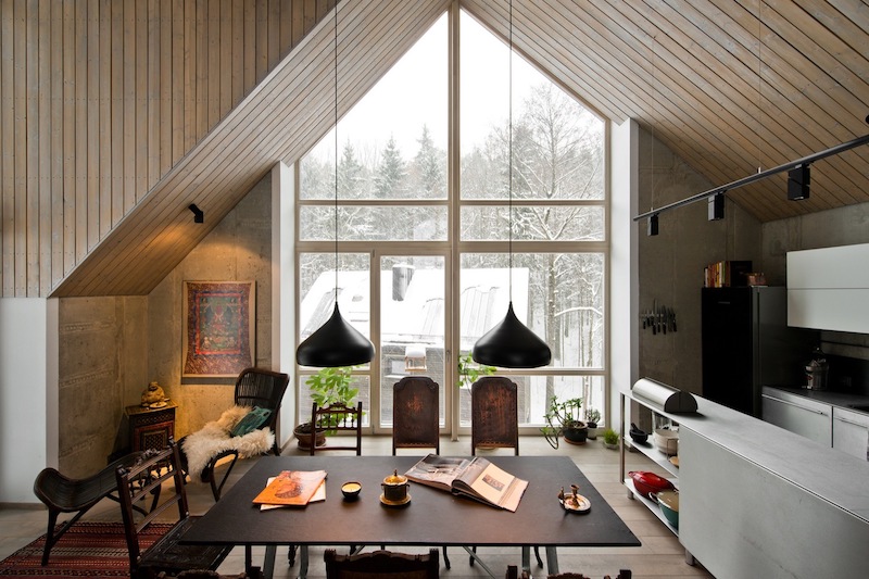 Attic wooden ceilings and large windows make the guests feel like in a countryside house