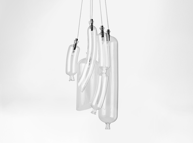 The lamps are made of glass, and it highlights the shapes of the sausages
