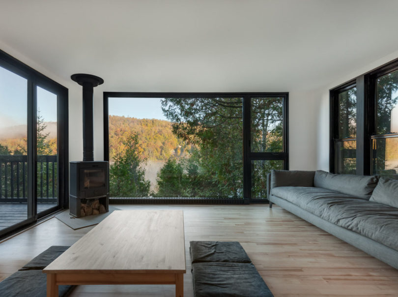 The living room is connected to this zone, it features much glazing and simple furnishings plus a metal hearth