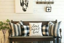 03 a barn-styled entryway with buffalo check pillows and calligraphy touches