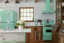 03 a mint fridge, a cooker and a hood give this rustic kitchen a retro feel