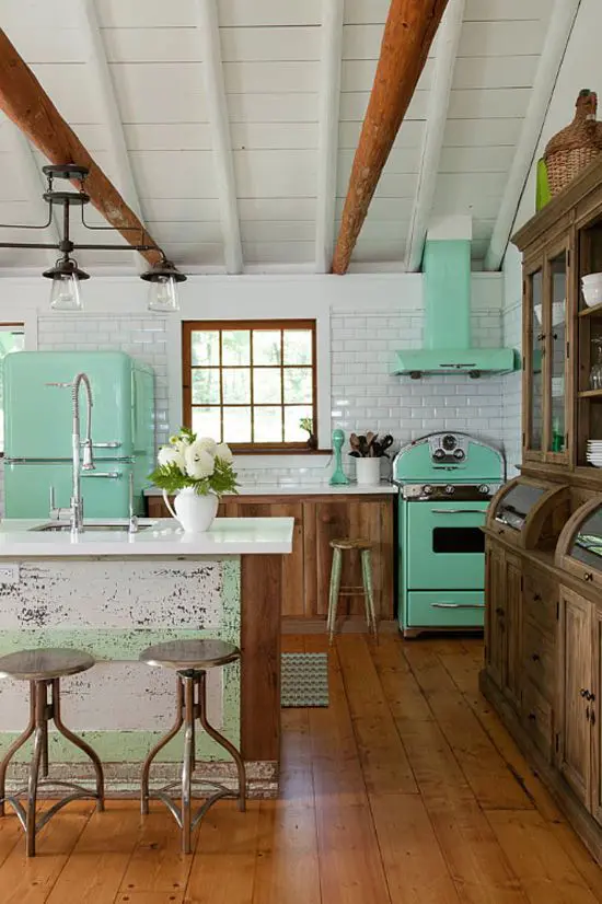 a mint fridge, a cooker and a hood give this rustic kitchen a retro feel