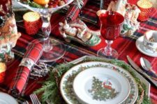 03 a plaid tablecloth and napkins add a cozy traditional feel to the table, and evergreens make it lively
