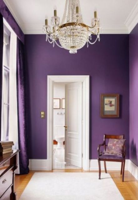 a violet statement wall and violet velvet curtains for a refined entryway