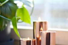 03 an arrangement of copper candle holders is a chic addition to any space