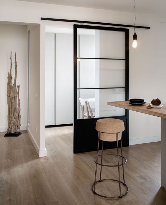 light-colored wood, cork, metal and a black glass sliding door