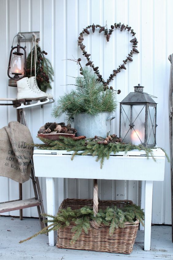 lush evergreens with pinecones, evergreens in a pot and a candle lantern