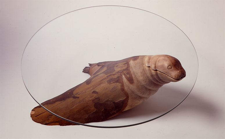 The Seal Table with a wooden seal and a glass tabletop