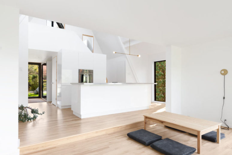 The living room is united with a kitchen and the spaces are divided into two parts with a different floor level