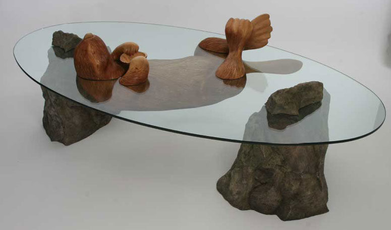 Sea Otter table features stones, a wooden otter and a glass tabletop