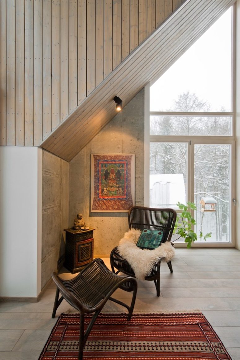 There's a comfy reading nook with a wicker chair and a boho rug