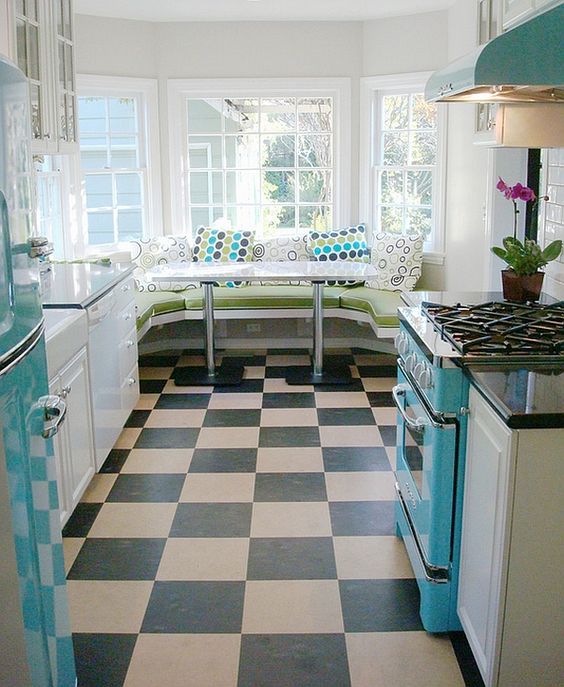 A turquoise fridge, hood and cooker and a diner inspired eating zone make the space retro