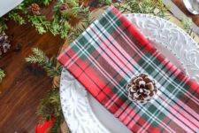 05 plaid napkins, red ribbons, evergreens and snowy pinecones will make up a gorgeous Christmas table