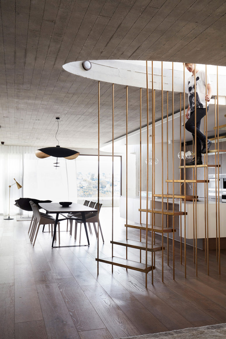 The stair is a concrete and brass piece, which connects all the levels of the house
