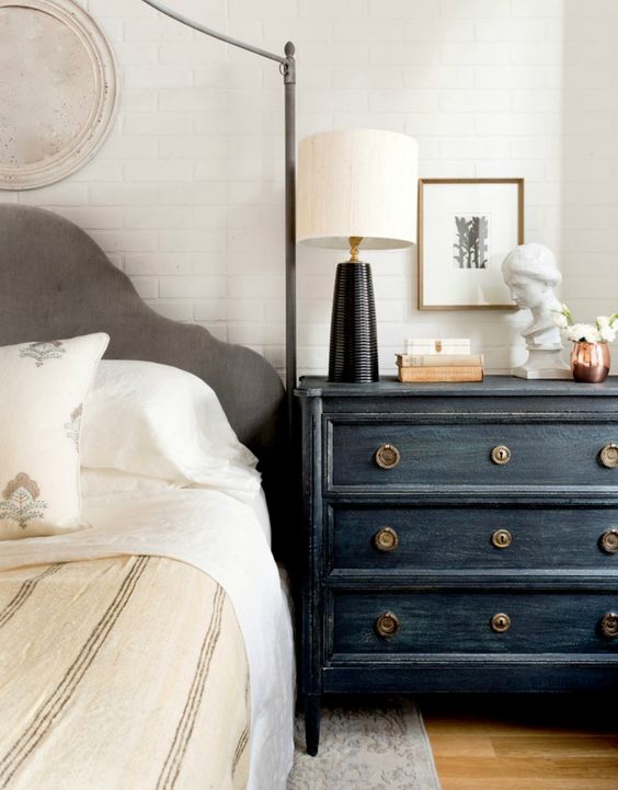 a black vintage dresser will add texture and interest to the space, and if it contrasts it, it will make a statement