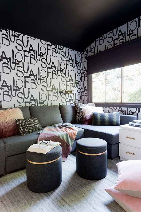 Graphic black and white wallpaper can be seen here, too, and the ceiling is painted black
