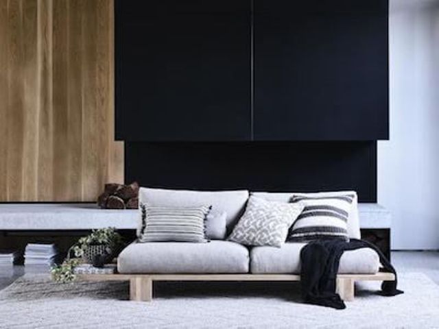 a comfy nook in dove grey, black and light-colored wood is a fantastic Japandi idea