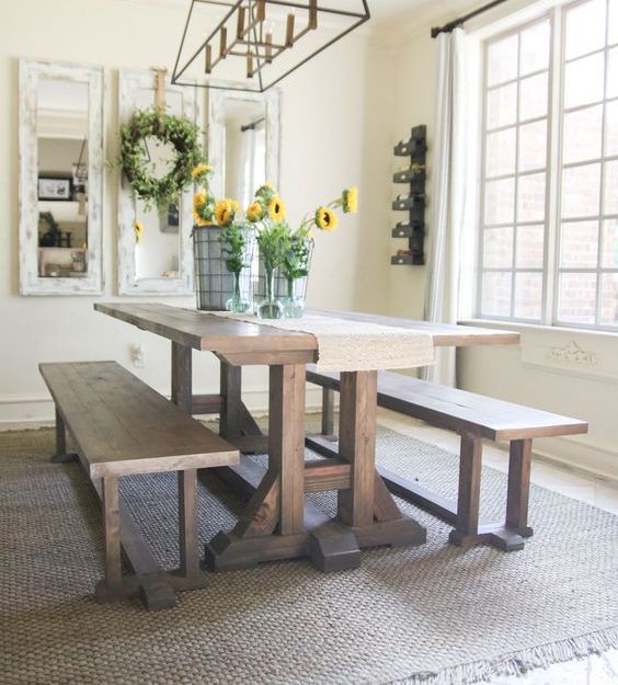 a simple rustic dining space with a trestle dining table and matching benches