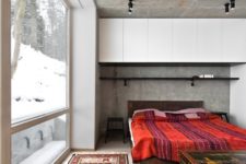 07 the master bedroom features raw concrete, wood and boho textiles and carved wooden items