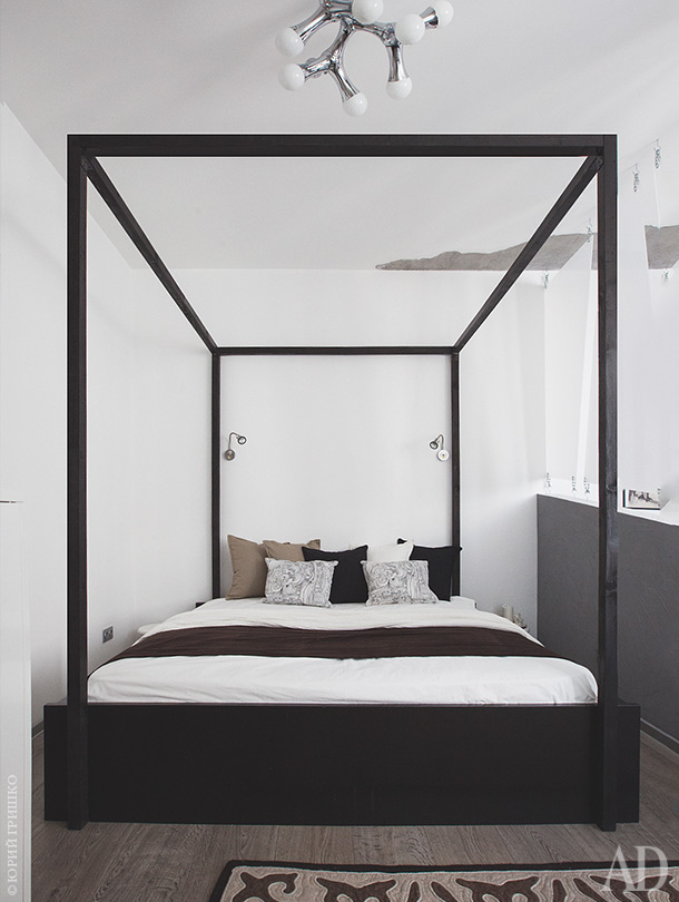 The bedroom is done with a canopy bed and is separated from the living room with a plexiglass divider