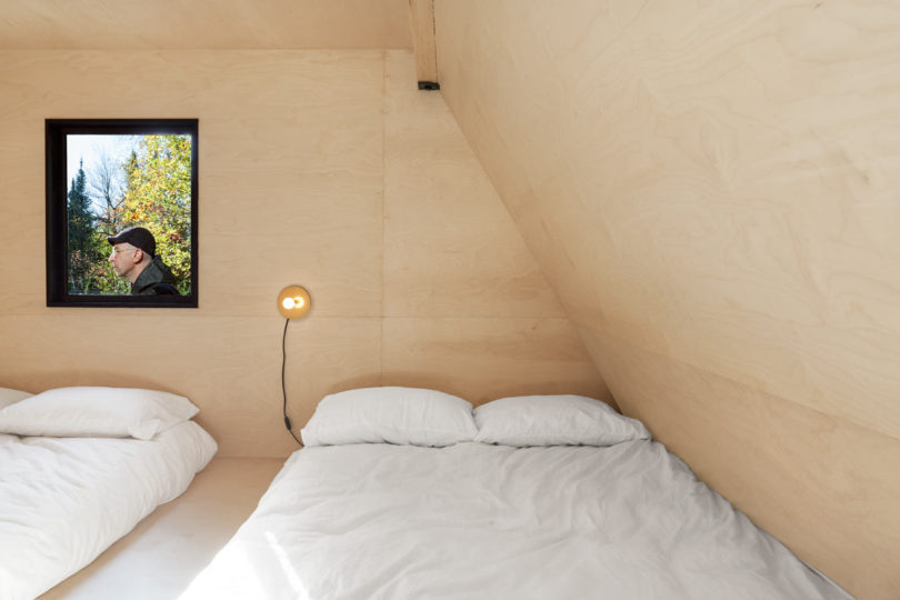 The kids' room features much plywood, a platform with two beds and storage space inside