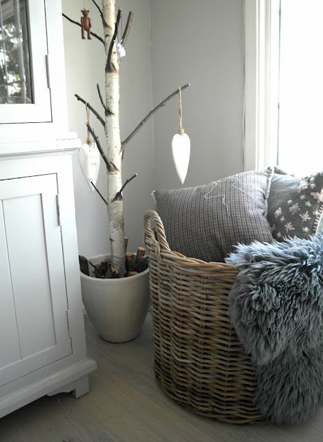 a basket with faux fur and pillows for a Scandinavian bedroom