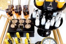 08 a brass bar cart with glitter bottles, fringe cupcake toppers and a glitter clock