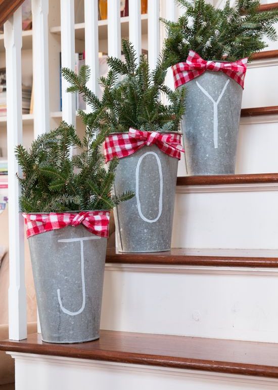 buckets with evergreen branches and plaid ribbons for a cool rustic feel