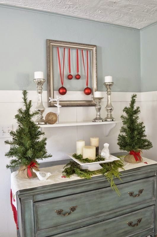 evergreen trees, a display with evergreens and candles and a framed ornament artwork